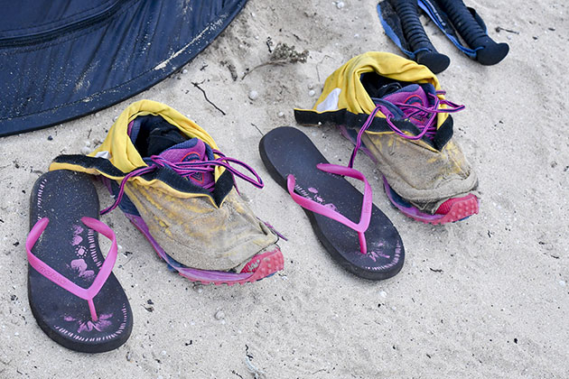 Photo of the pair of the trail shoes and the flit flop of a participant