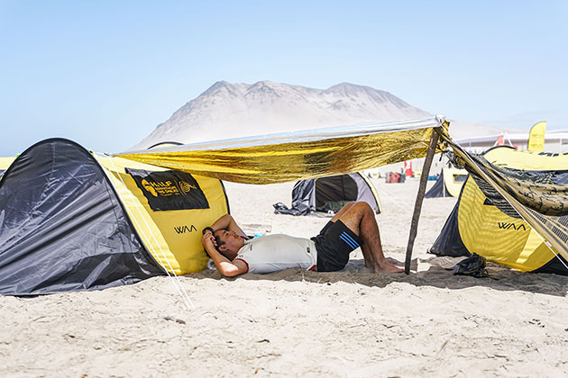 Photo of a participant of the HMDS having a nap on the bivouac between two tents
