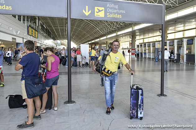 Photo of a participant with his backpack at the airport