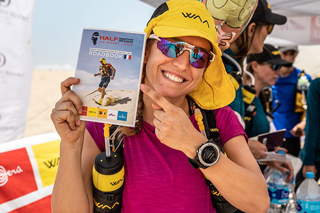 A participant holding the HMDS road book